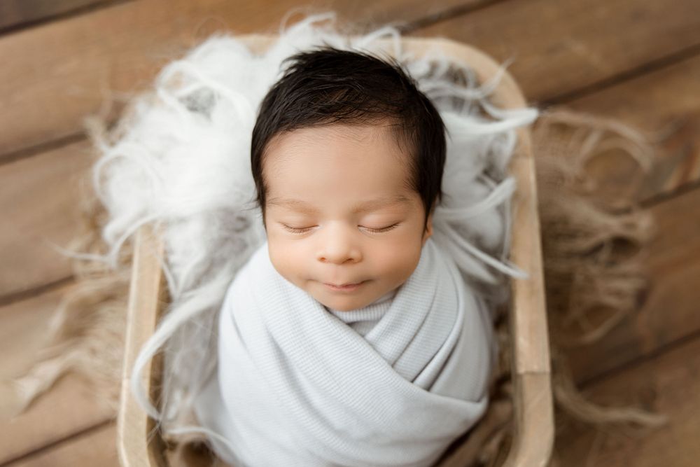 gray color newborn baby wrapped