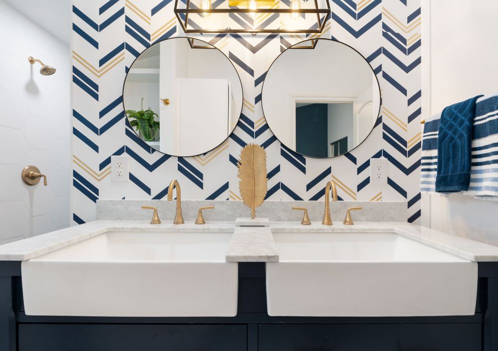 Contemporary bathroom vanity with dual sinks and blue chevron wallpaper pattern.