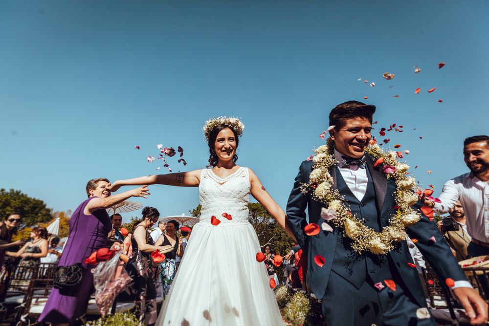 Celebratory moment with confetti during an outdoor wedding reception.