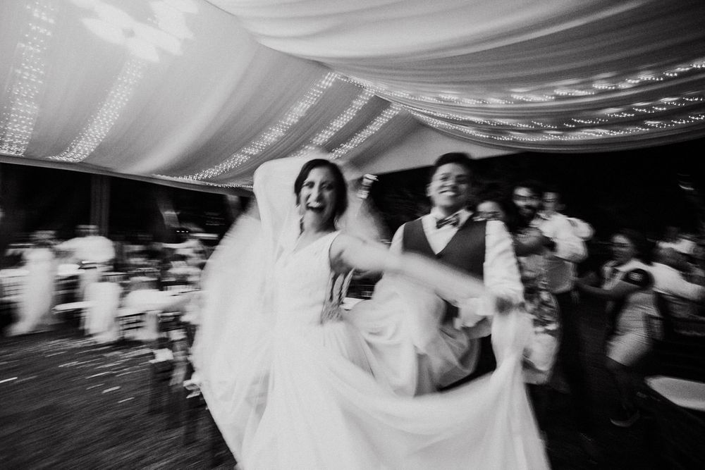 Black and white photos show guests dancing and celebrating under a tented wedding reception.