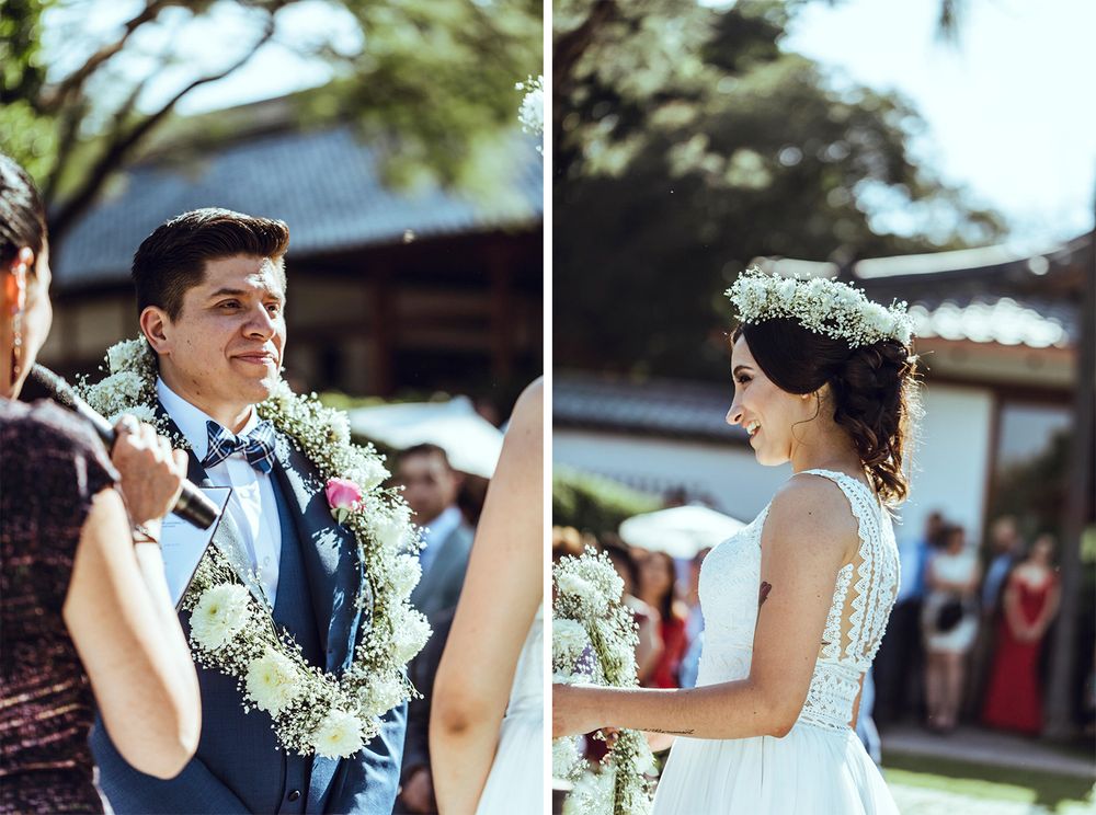 Wedding ceremony participants exchange leis in a traditional outdoor celebration.