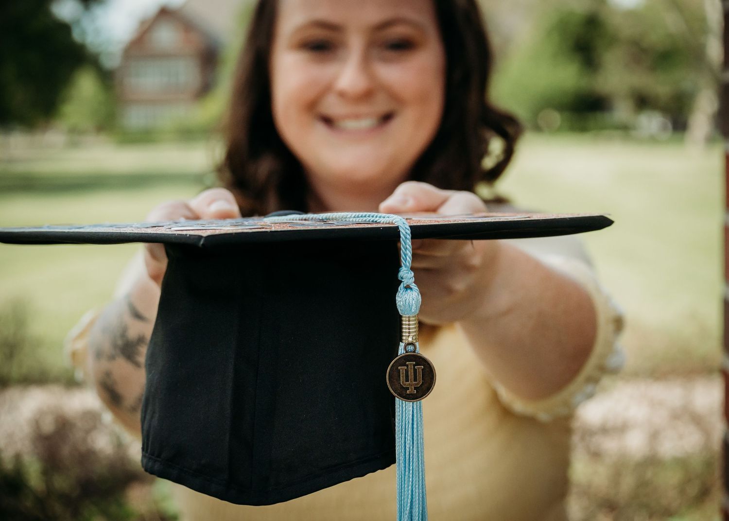 college graduate holding graduation cap