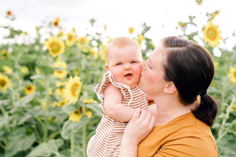 Tender moment captured in blooming sunflower garden on sunny day.