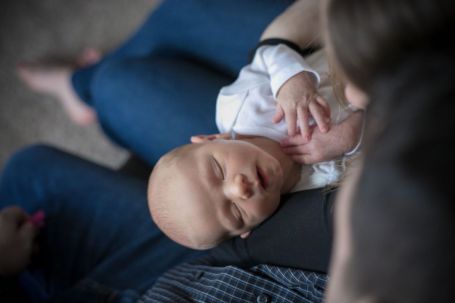 Mother and Father holding their new baby boy during his newborn session in Sioux City, IA.