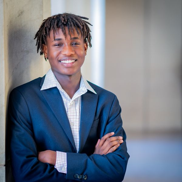 A Edmund Burke School high school senior smiles during his senior portraits in Washington DC.
