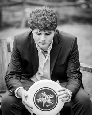 A Maret ultimate player looks down at his frisbee during his senior portraits.