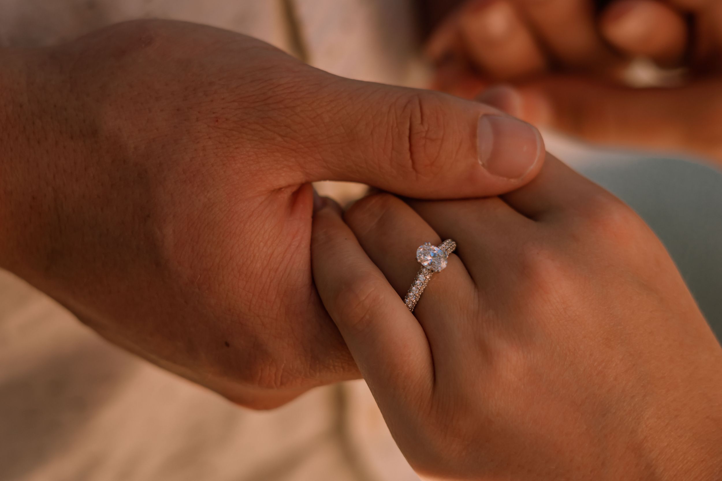 engagement ring detail shot with both partners hands