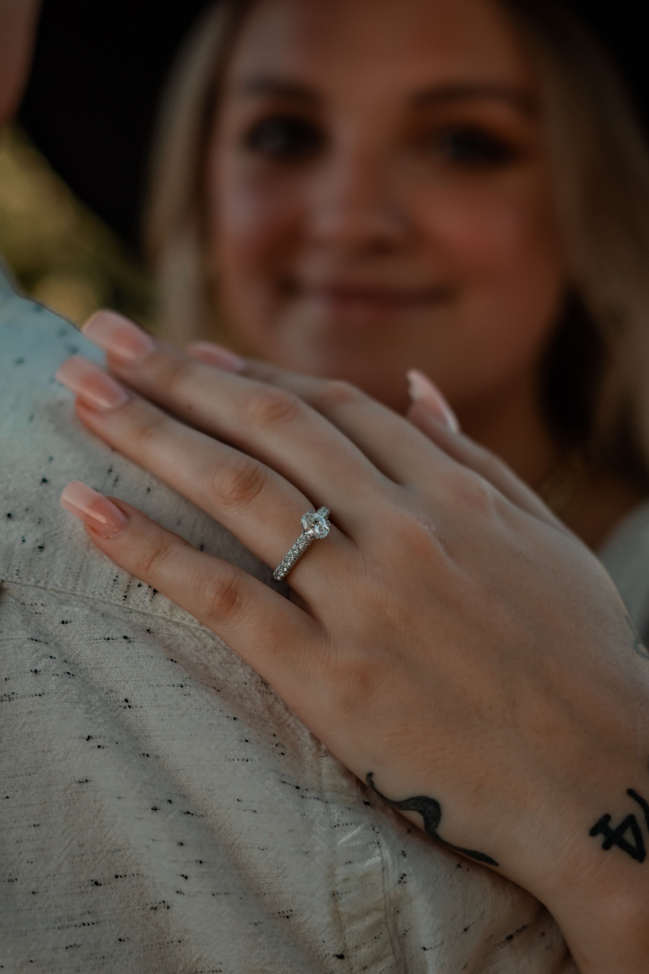 engagement ring detail shot showing bride's face