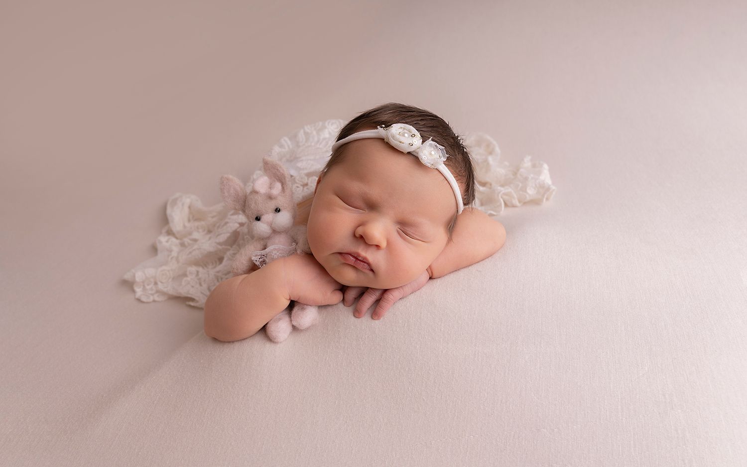 simple posed on baby's hand styled with teddy in a sleepy pose