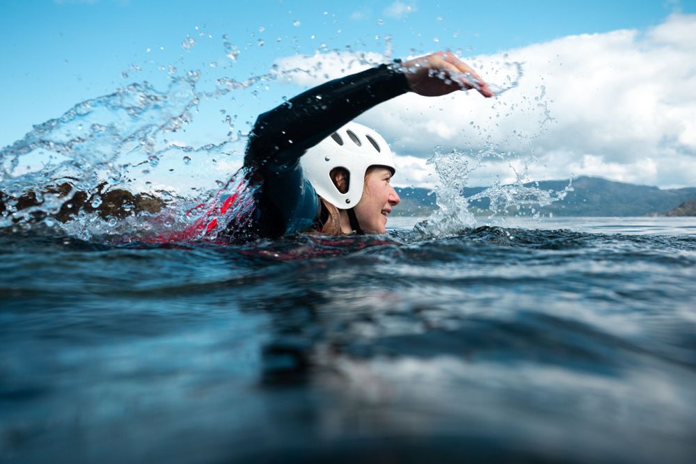 Seatrek Scotland client swims front crawl in sea with water trail viewed from surface