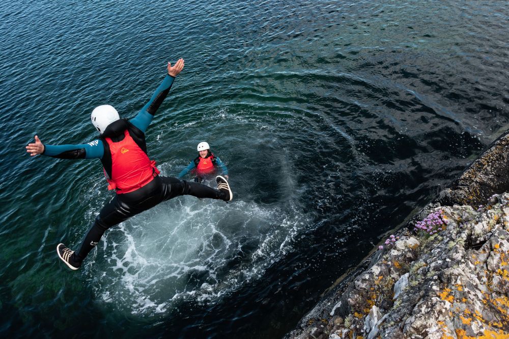 Seatrek Scotland client jumps into sea with a star jump