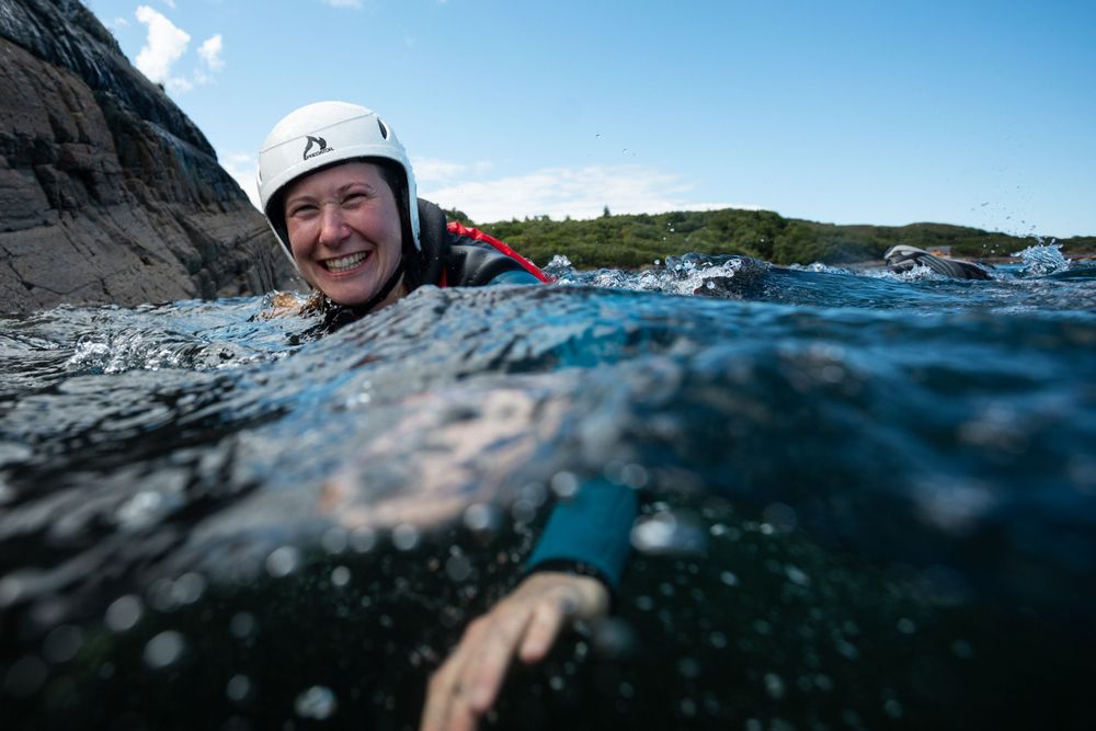 Seatrek Scotland client smiles as she swims, viewed from surface