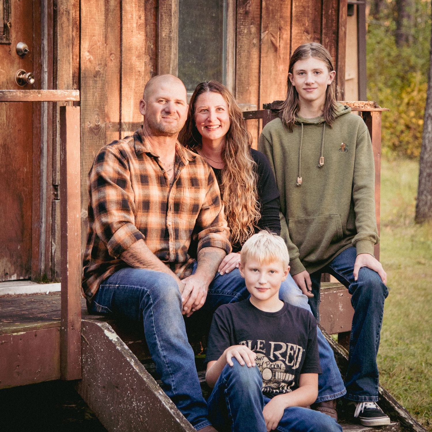 Family sitting by the cabin