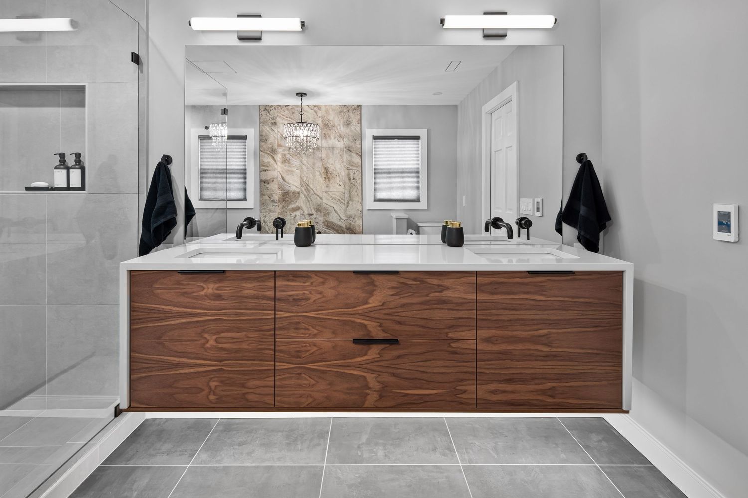 Sleek remodeled bathroom with gray tile and wood cabinets from an Ohio interior design photo shoot.