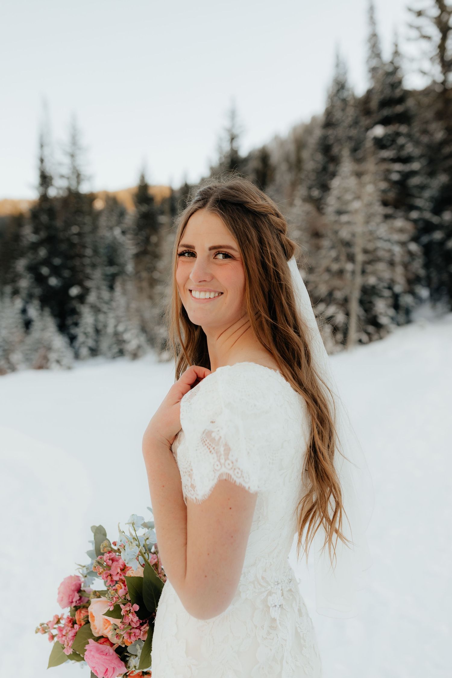 Bride with flowers in winter pine forest