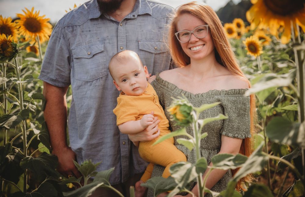 Candid family moment captured in beautiful sunflower garden setting.