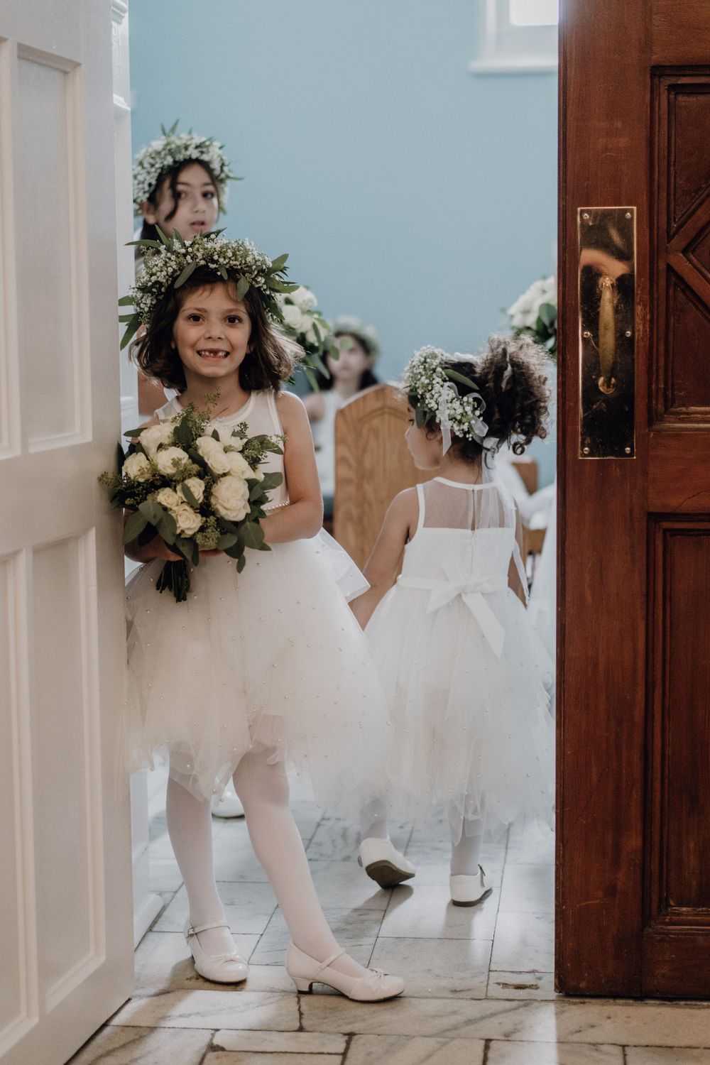 Flower girl holding a bouquet before the ceremony begins