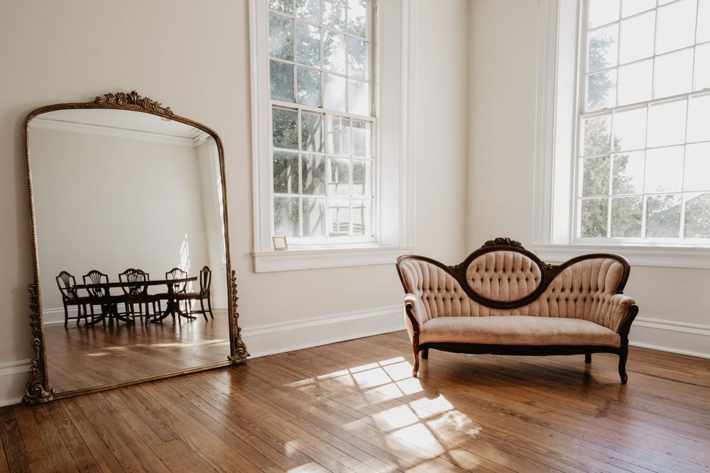 Antique setee and gold mirror