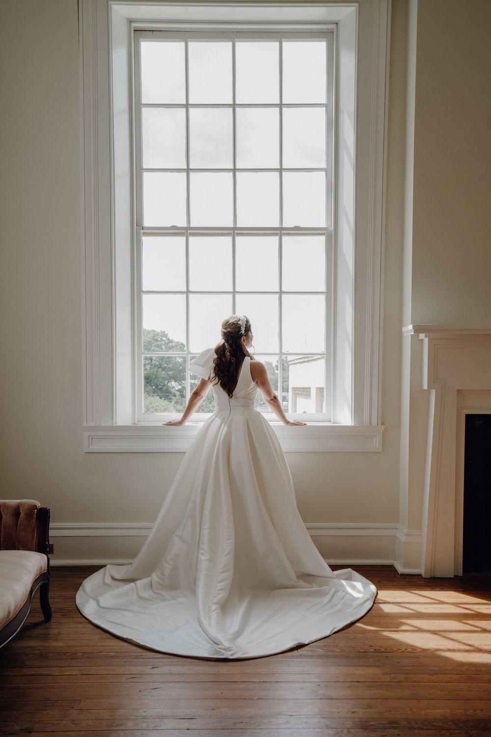 Bride portrait standing on front of a large window