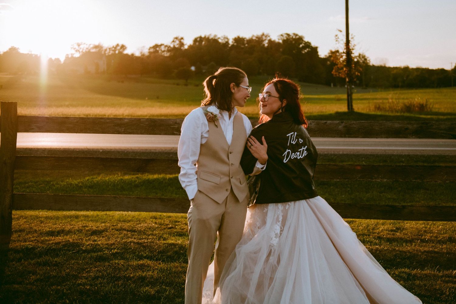 brides looking into each other eye's with a beautiful sunset in the background