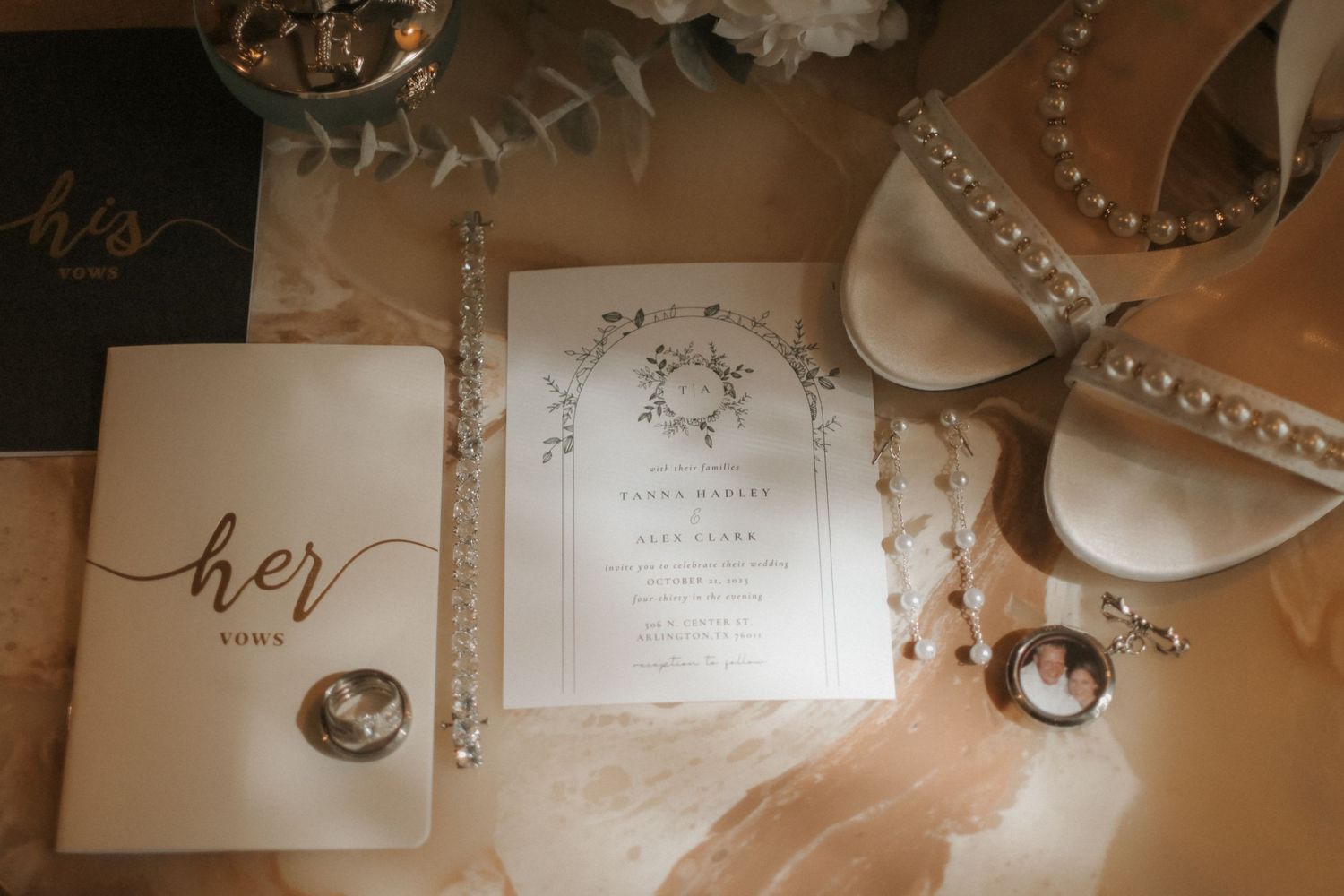 Wedding stationery and invitation suite displayed with decorative elements in warm lighting.