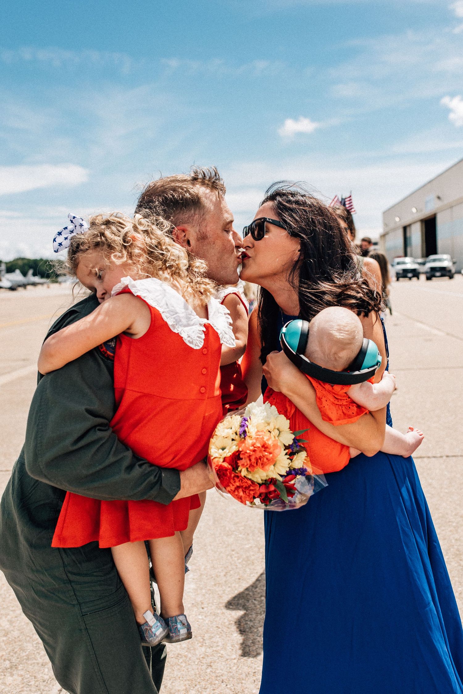 family reuniting on the airfield for naval military homecoming in virginia beach, virginia