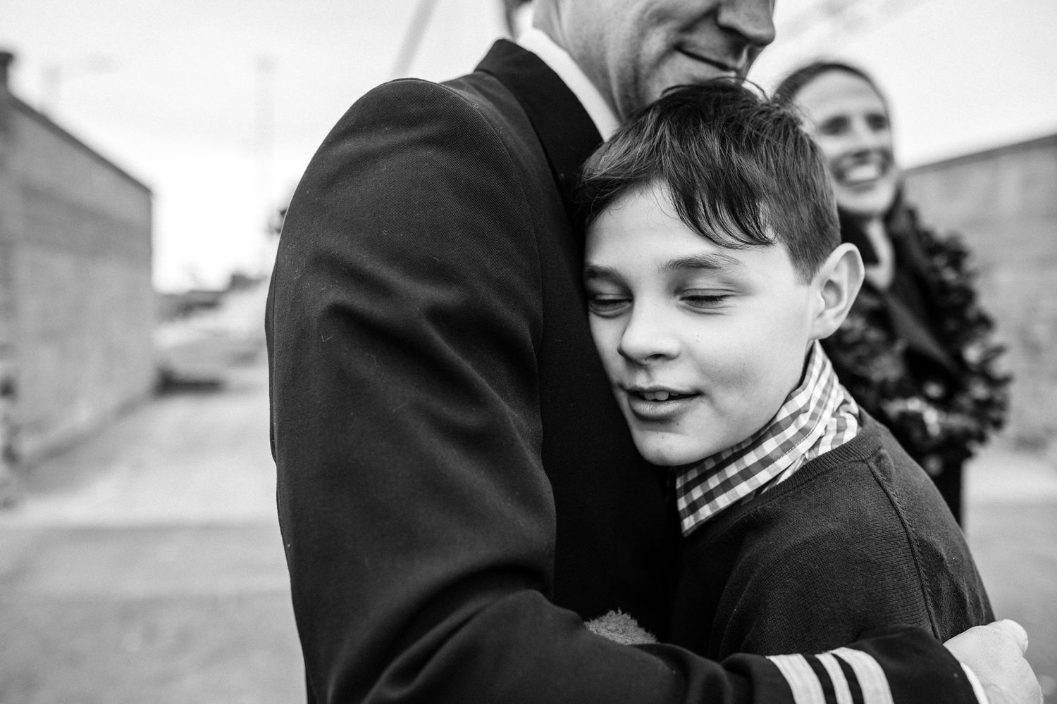 dad embracing son at navy military homecoming in norfolk, virginia base
