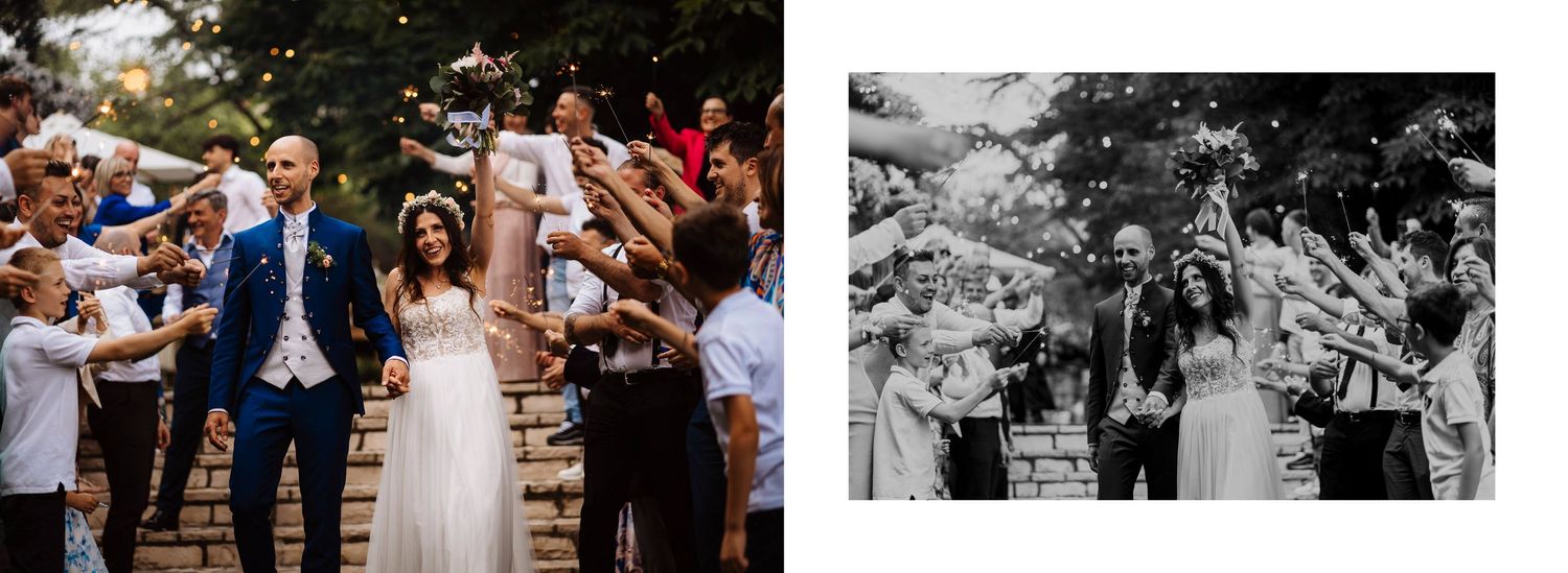 Bride and groom celebrating with guests tossing confetti on outdoor staircase at wedding reception.