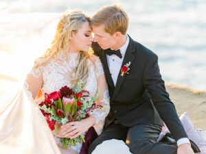 Bride and groom portrait sitting on the beach in San Diego