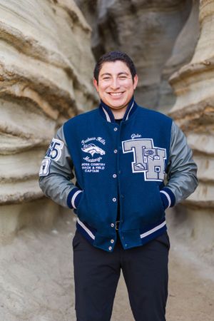High school senior boy session next to rock formation in San Clemente