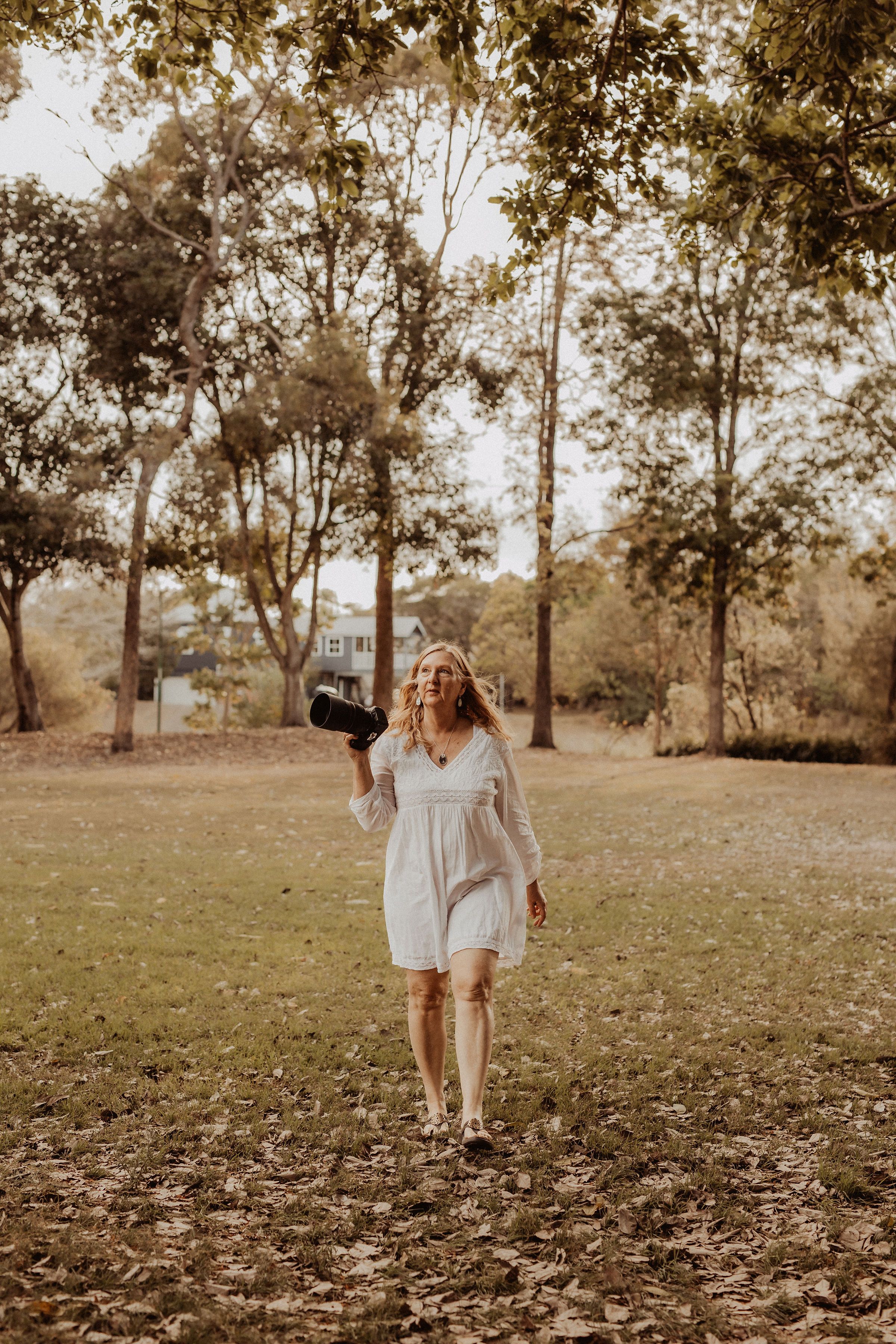 photographer in park with camera.Leigh Ball Photography, Macedon Ranges Vic.