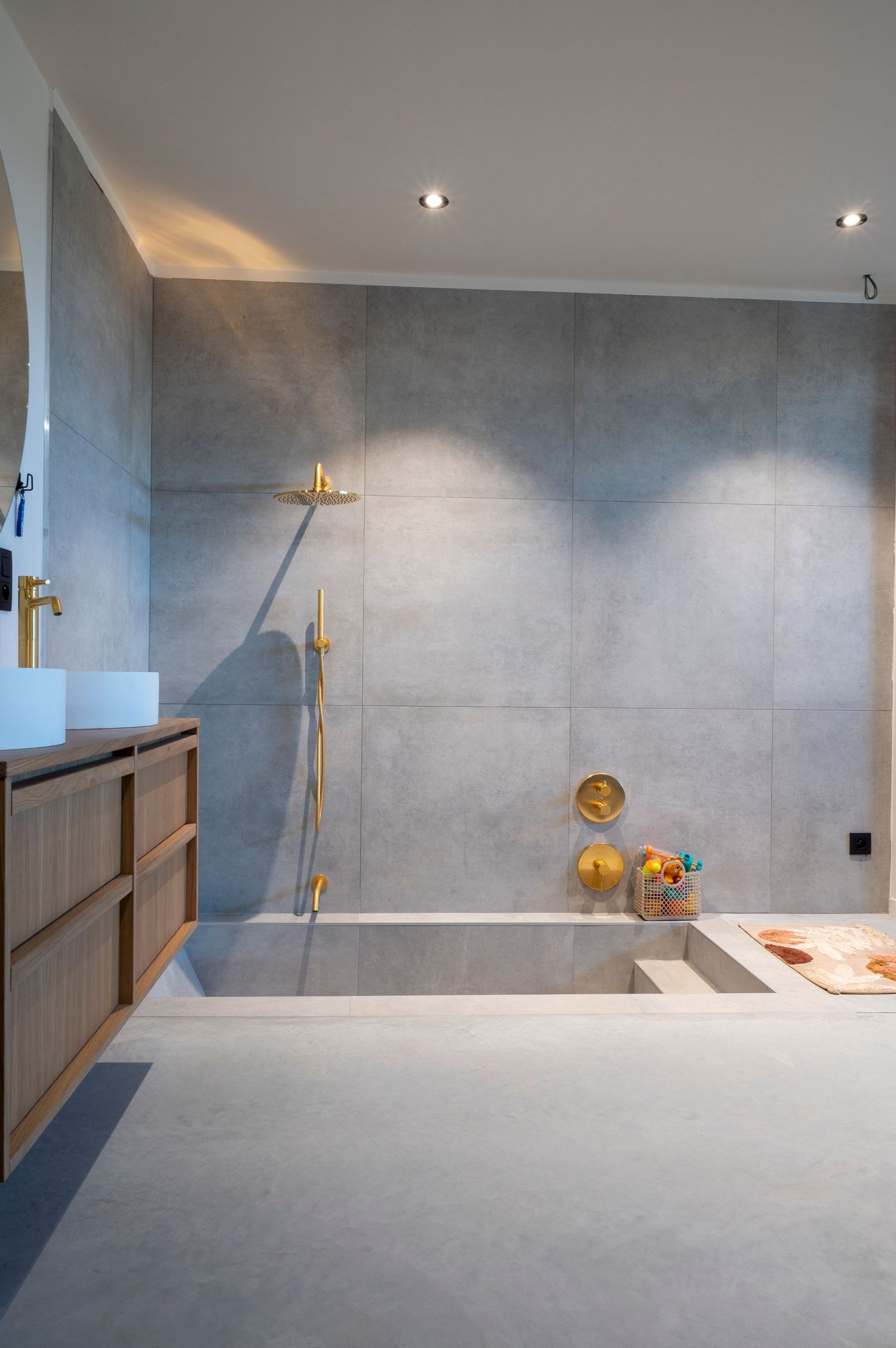 Modern grey concrete interior space with recessed lighting and minimalist design features.