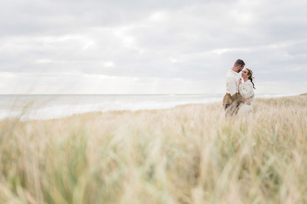 The couple looking into each other's eyes. Beach engagement session