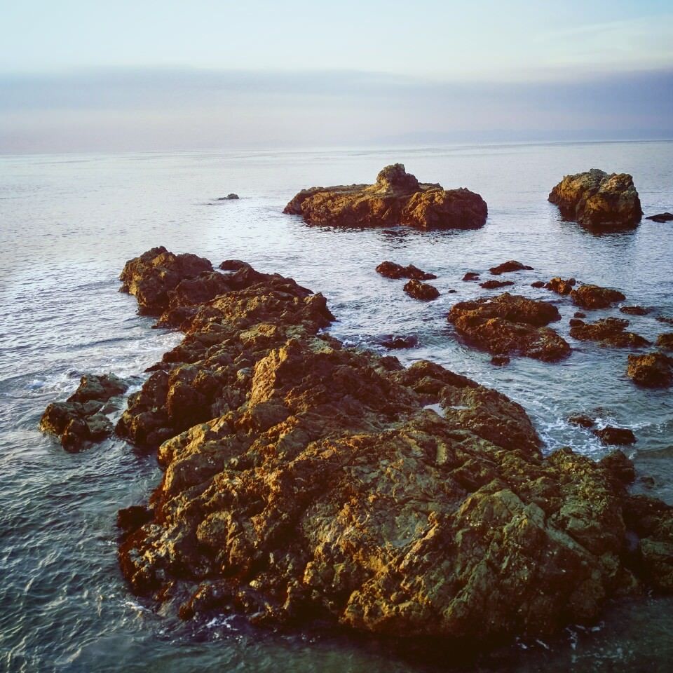 Water calmly lapping at rocks in the bay