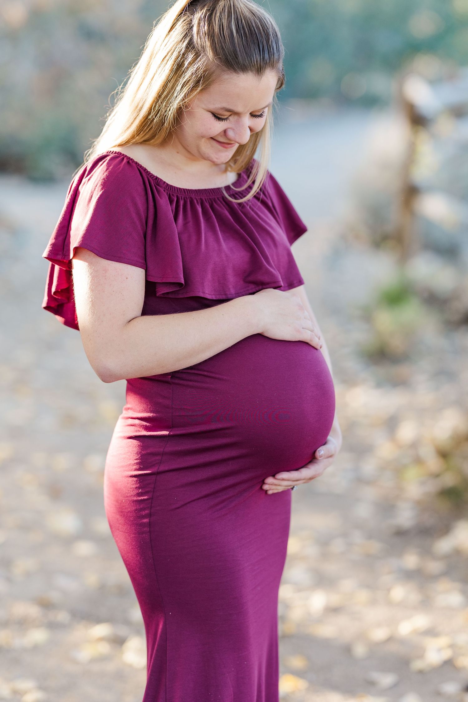Maternity session with mom looking down at belly