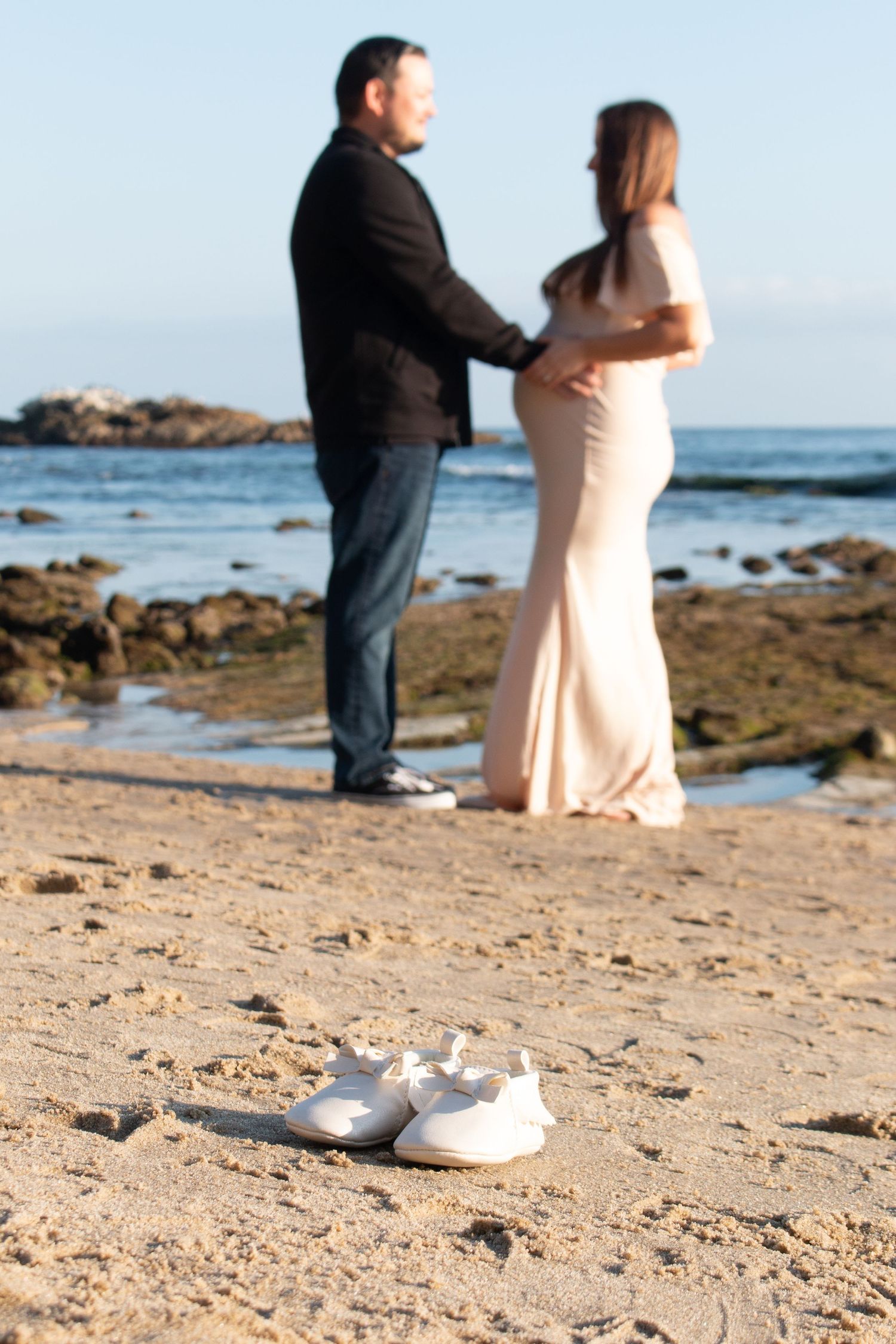 Maternity session with baby shoes at Laguna Beach