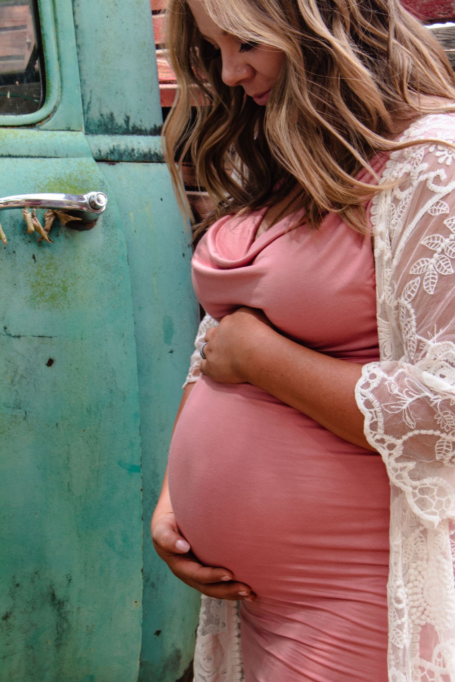 Maternity session with mom looking down at belly