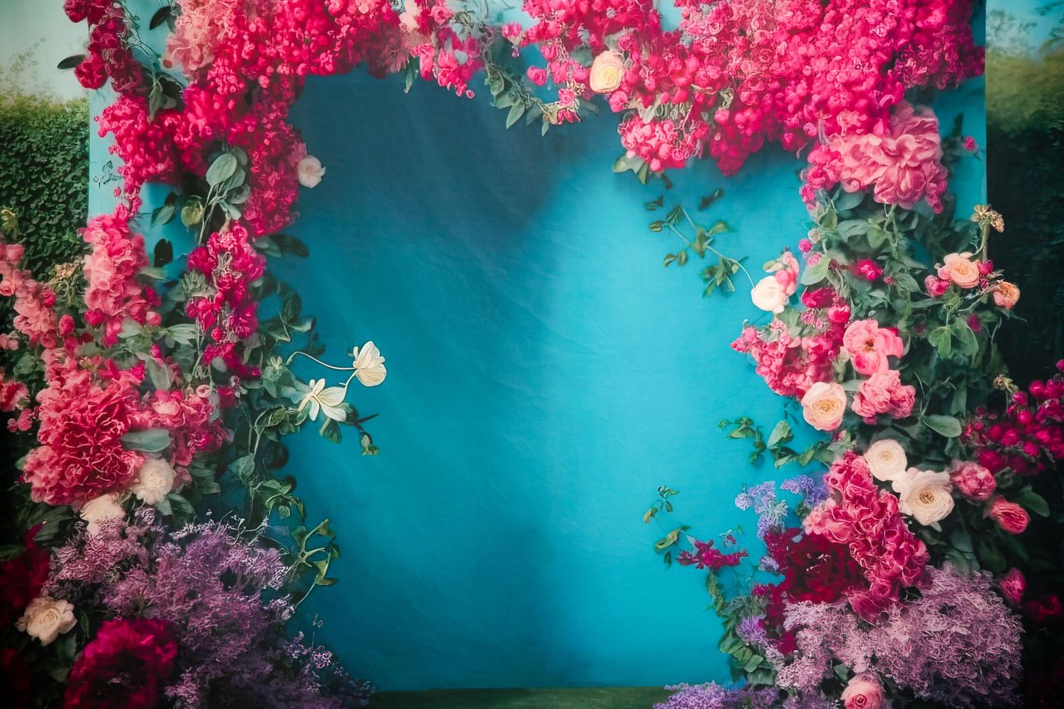 Romantic floral arch with vibrant pink flowers and butterflies against a turquoise background.