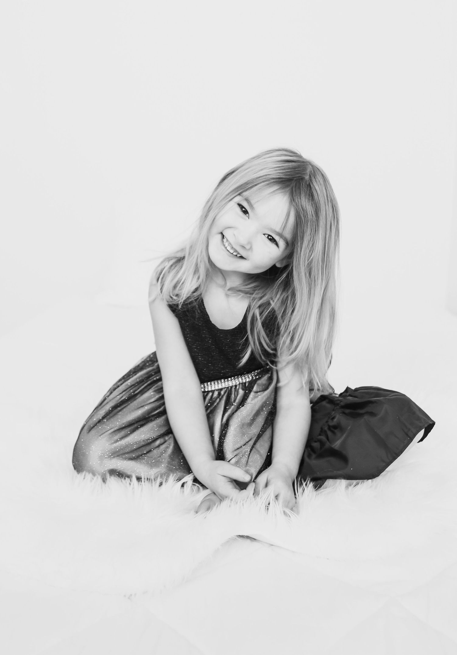 Black and white studio portraits showing relaxed poses on white background.