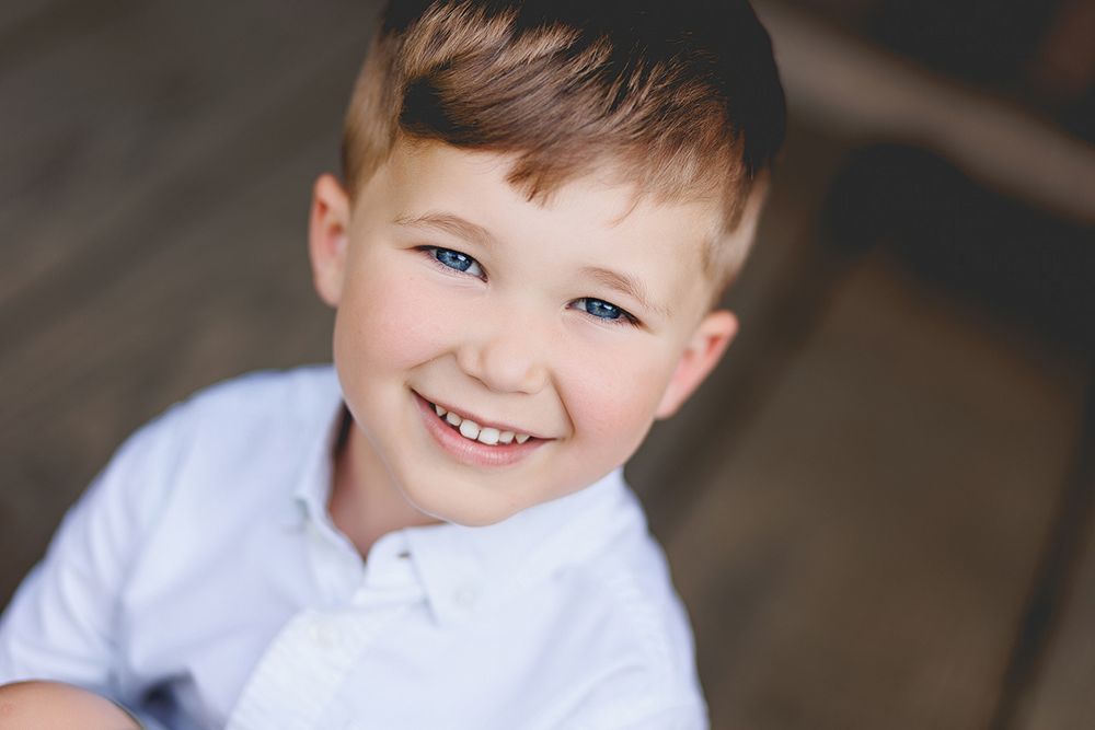 Close-up portrait showcasing bright eyes and joyful expression.