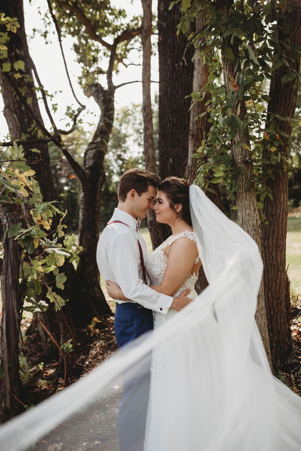 Bride and groom, country setting, flowing veil