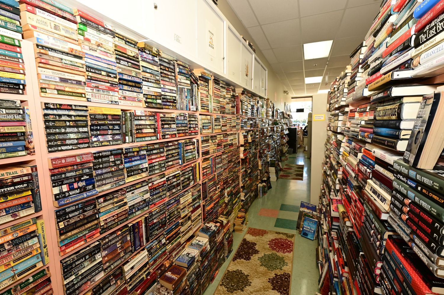 Fisheye lens view of a bookstore showing multiple aisles of shelves filled with books.