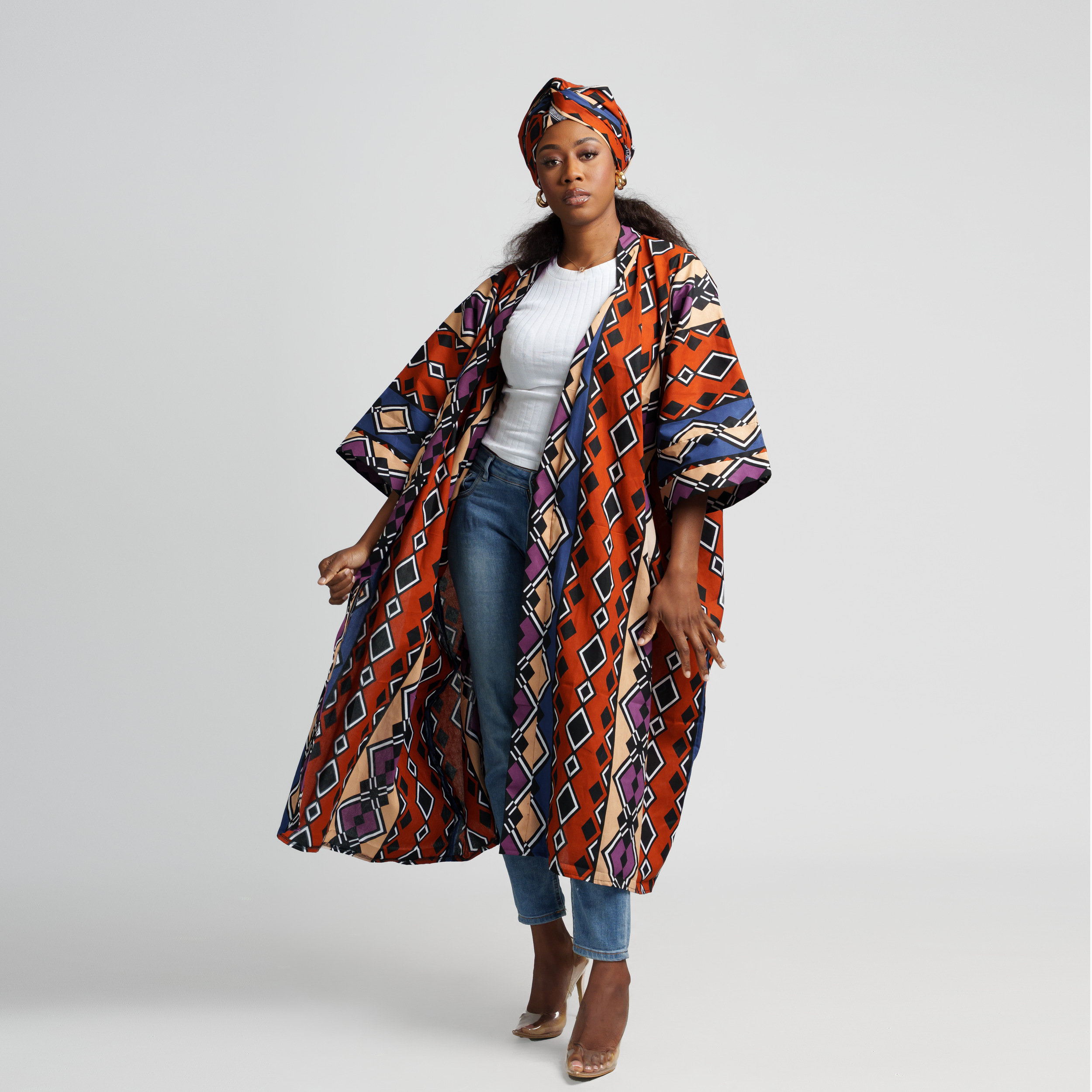 Colorful African print kimono coat styled with white top, jeans and matching headwrap.