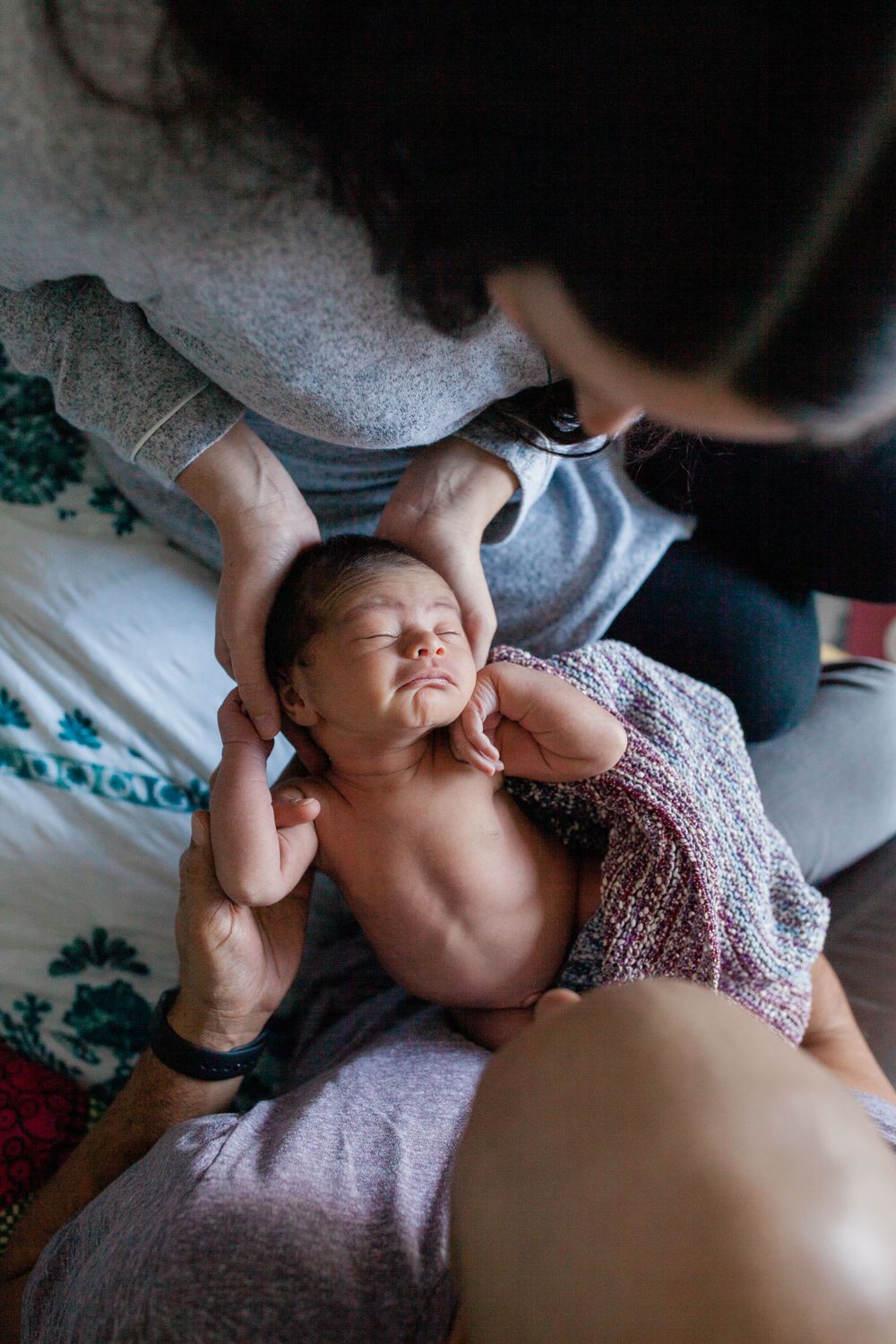 Tender moments captured between family members during an intimate photoshoot.