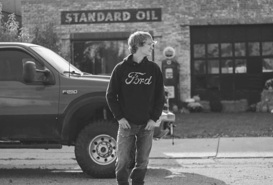 Vintage Standard Oil station exterior with classic Ford vehicle visible.