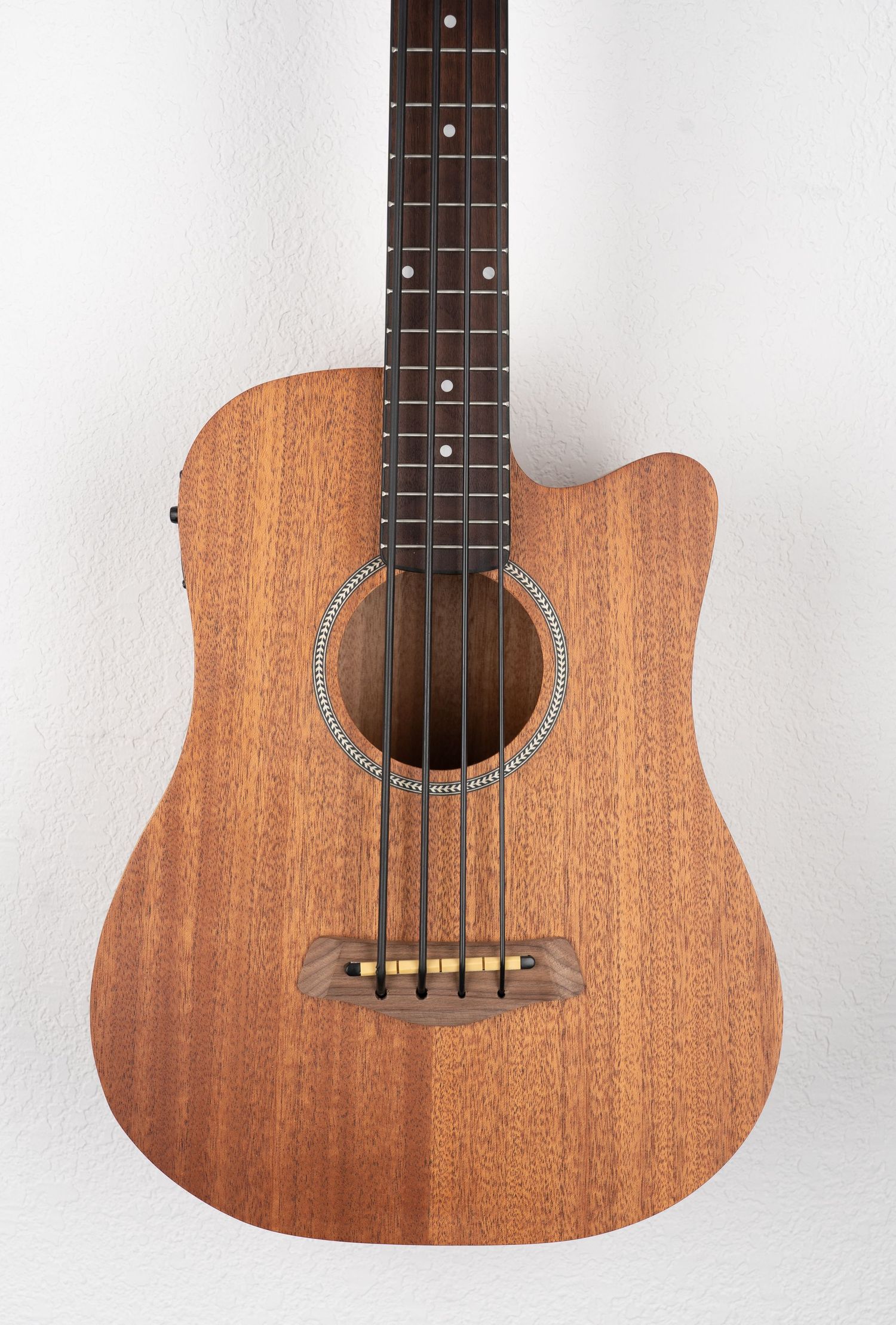 Acoustic-electric bass guitar with mahogany body and cutaway design featuring built-in electronics.