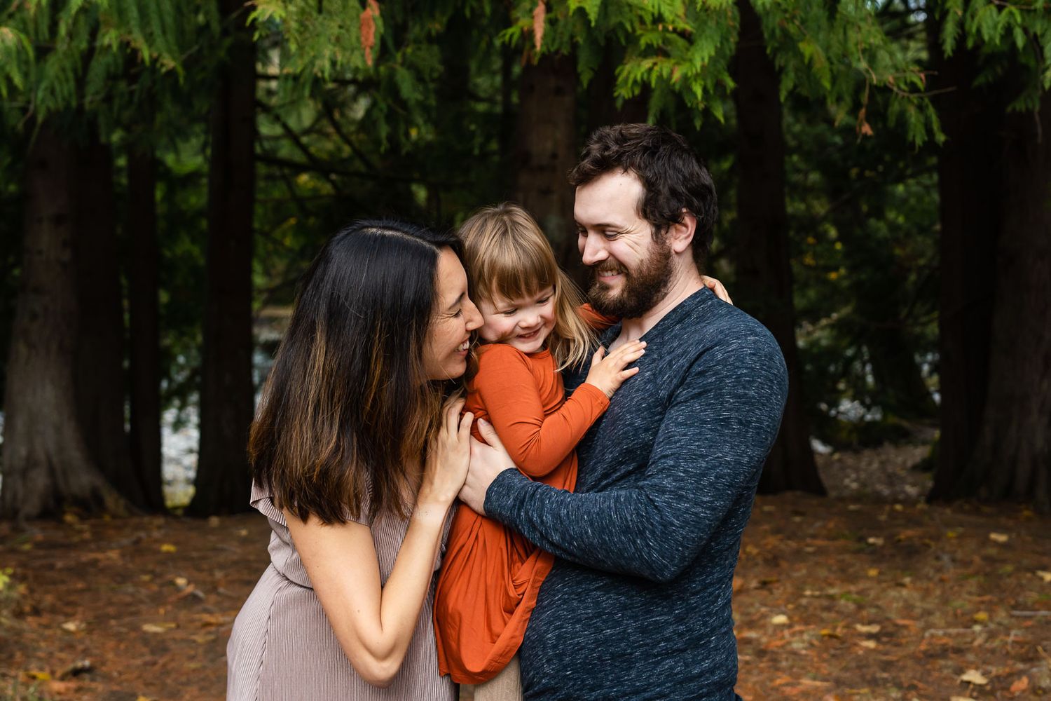 Parents snuggle with daughter at Tanner Landing park in North Bend.