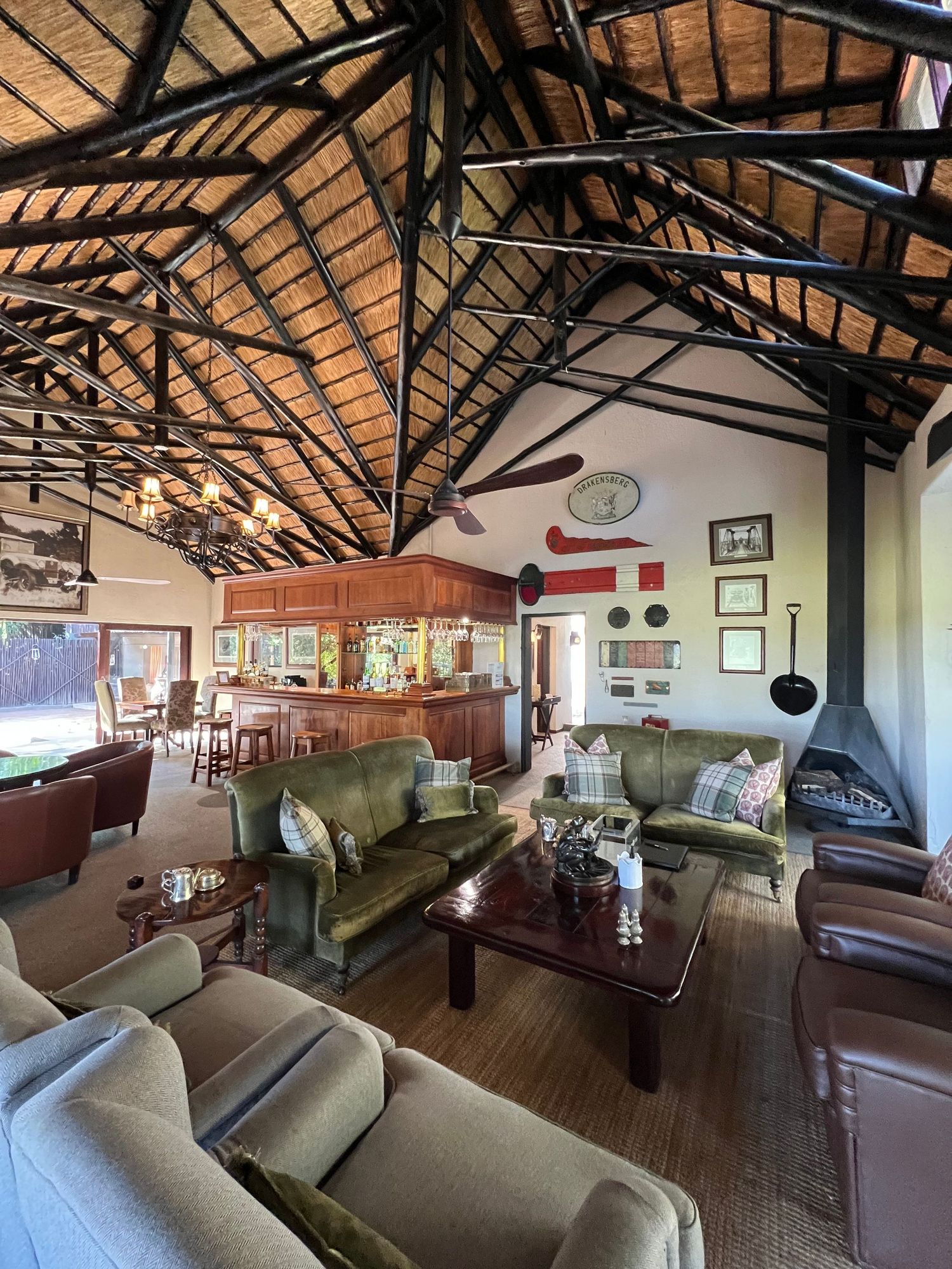 Luxurious lodge lounge with exposed wooden beams and comfortable seating arrangements.