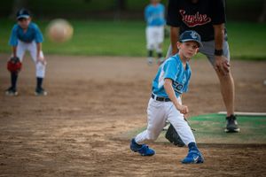 baseball pitcher delivering a pitch with ball