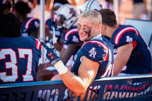 football player giving peace sign
